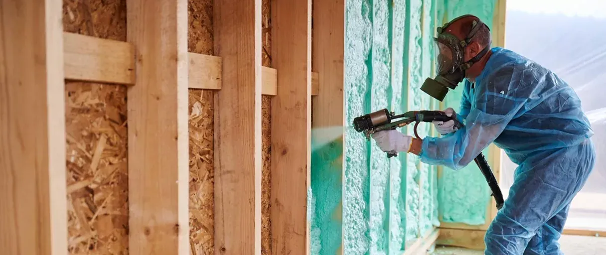 Applicator spraying closed-cell foam during hands-on training